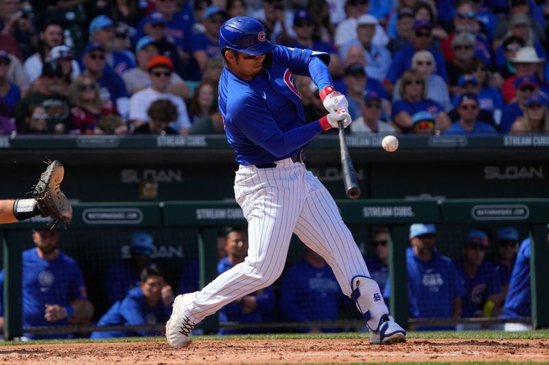 Mar 14, 2024; Mesa, Arizona, USA; Chicago Cubs starting pitcher Shota Imanaga (18) hits a single against the Oakland Athletics in the third inning at Sloan Park. Mandatory Credit: Rick Scuteri-USA TODAY Sports