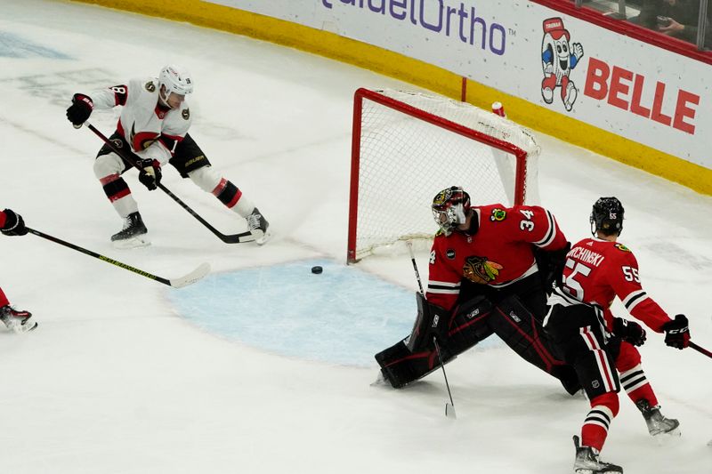 Feb 17, 2024; Chicago, Illinois, USA; Ottawa Senators center Tim Stutzle (18) scores a goal on Chicago Blackhawks goalie Petr Mrazek (34) during the first period at United Center. Mandatory Credit: David Banks-USA TODAY Sports