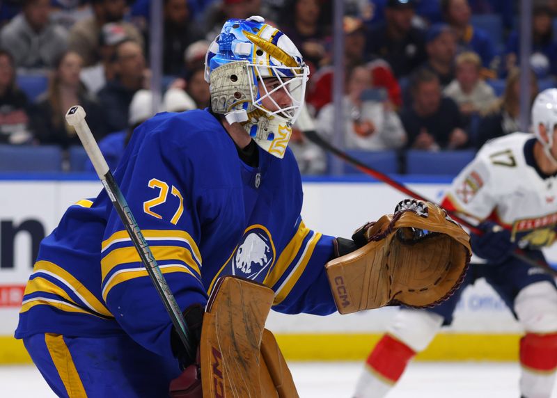 Oct 12, 2024; Buffalo, New York, USA;  Buffalo Sabres goaltender Devon Levi (27) looks for the puck during the first period against the Florida Panthers at KeyBank Center. Mandatory Credit: Timothy T. Ludwig-Imagn Images