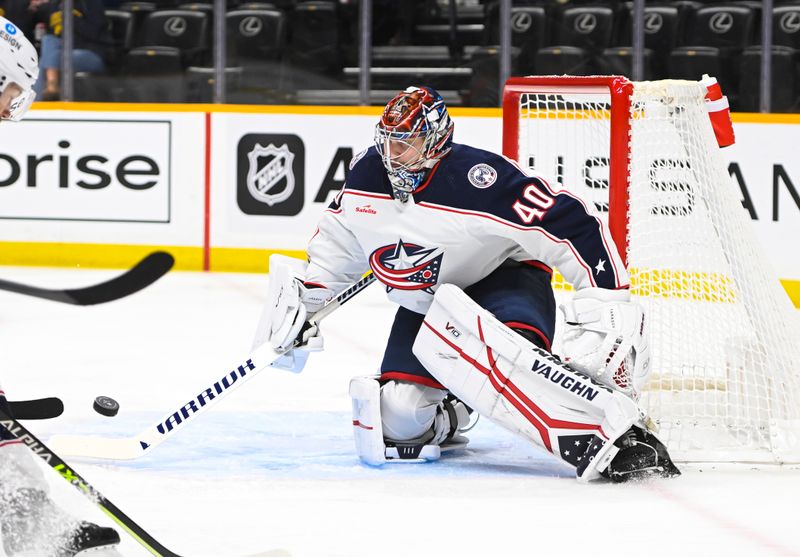 Jan 17, 2023; Nashville, Tennessee, USA;  Columbus Blue Jackets goaltender Daniil Tarasov (40) blocks the puck against the Nashville Predators during the first period at Bridgestone Arena. Mandatory Credit: Steve Roberts-USA TODAY Sports