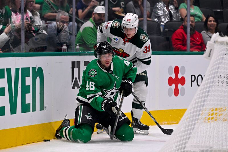 Sep 23, 2025; Dallas, Texas, USA; Dallas Stars defenseman Ilya Lyubushkin (46) and Minnesota Wild center Ben Jones (39) battle for control of the puck during the first period at American Airlines Center. Mandatory Credit: Jerome Miron-Imagn Images