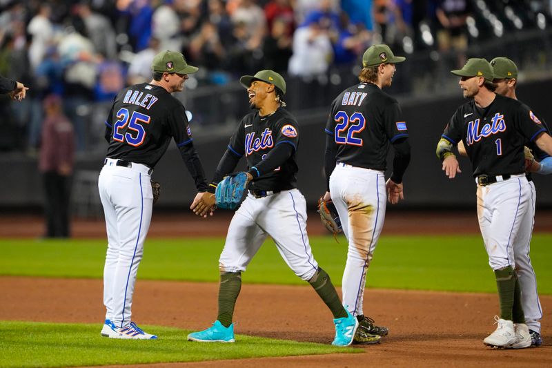 May 21, 2023; New York City, New York, USA; New York Mets pitcher Brooks Raley (25) and shortstop Francisco Lindor (12) low five to celebrate the victory after the game against the Cleveland Guardians at Citi Field. Mandatory Credit: Gregory Fisher-USA TODAY Sports