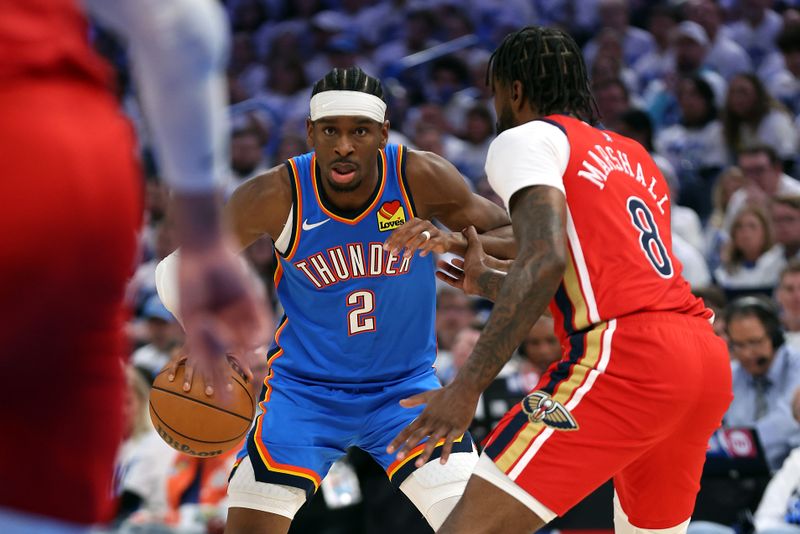 OKLAHOMA CITY, OKLAHOMA - APRIL 24:  Shai Gilgeous-Alexander #2 of the Oklahoma City Thunder controls the ball as Naji Marshall #8 of the New Orleans Pelicans defends during game two of the first round of the NBA playoffs at Paycom Center on April 24, 2024 in Oklahoma City, Oklahoma. (Photo by Jamie Squire/Getty Images)