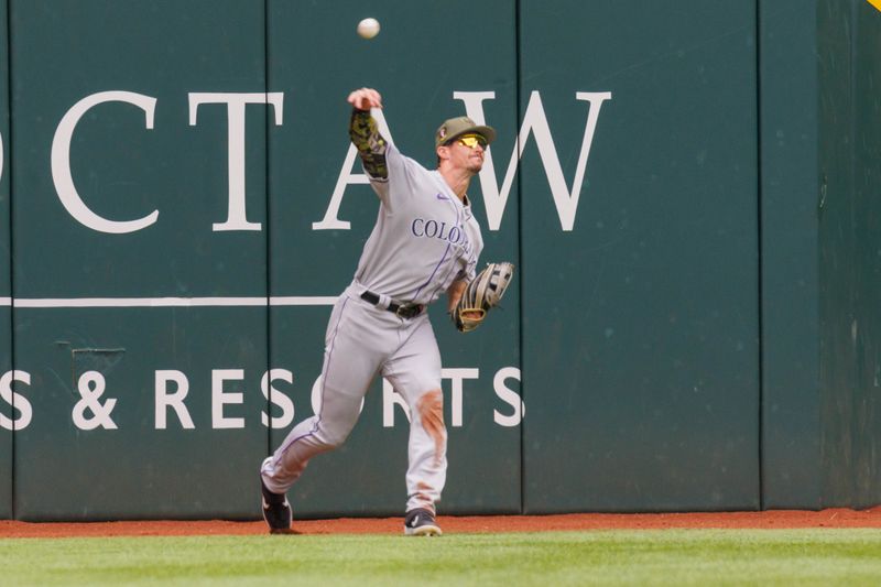 May 21, 2023; Arlington, Texas, USA; Colorado Rockies center fielder Brenton Doyle (9) throws the ball in after a hit by the Texas Rangers during the second inning at Globe Life Field. Mandatory Credit: Andrew Dieb-USA TODAY Sports