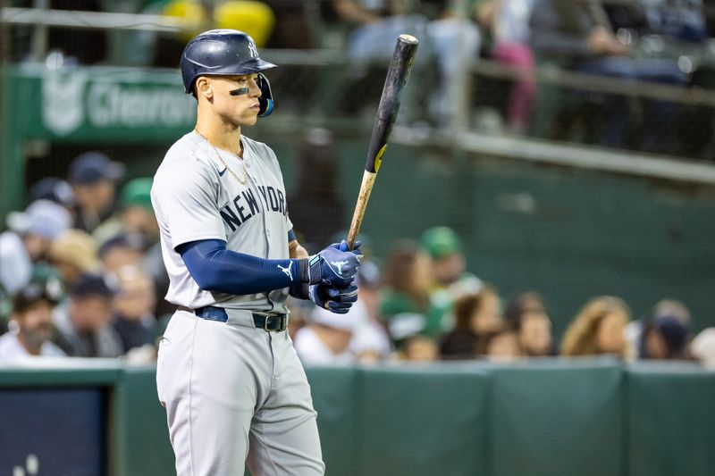 Sep 20, 2024; Oakland, California, USA; New York Yankees outfielder Aaron Judge (99) on deck during the sixth inning against the Oakland Athletics at Oakland-Alameda County Coliseum. Mandatory Credit: Bob Kupbens-Imagn Images