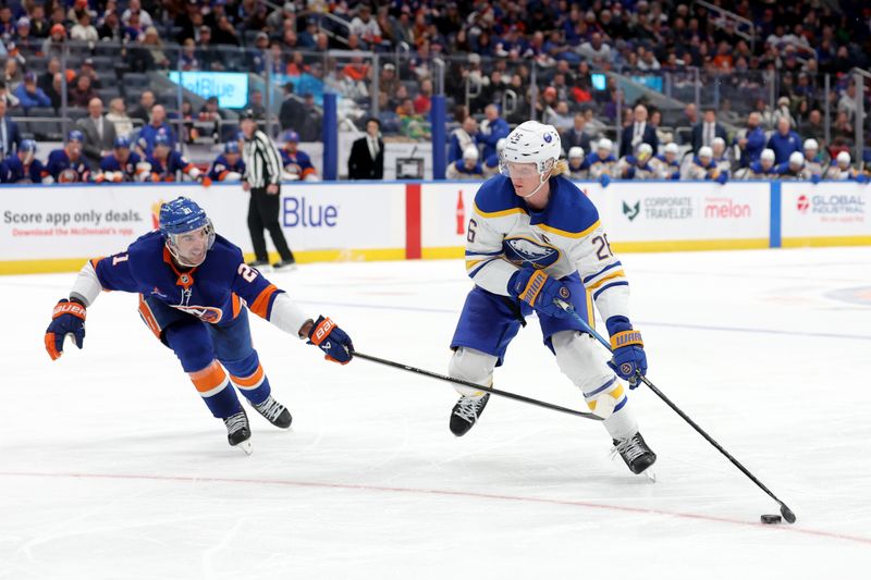 Nov 30, 2024; Elmont, New York, USA; Buffalo Sabres defenseman Rasmus Dahlin (26) skates with the puck against New York Islanders center Kyle Palmieri (21) during the third period at UBS Arena. Mandatory Credit: Brad Penner-Imagn Images