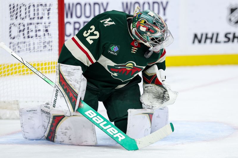 Jan 23, 2025; Saint Paul, Minnesota, USA; Minnesota Wild goaltender Filip Gustavsson (32) makes a save against the Utah Hockey Club during the first period at Xcel Energy Center. Mandatory Credit: Matt Krohn-Imagn Images