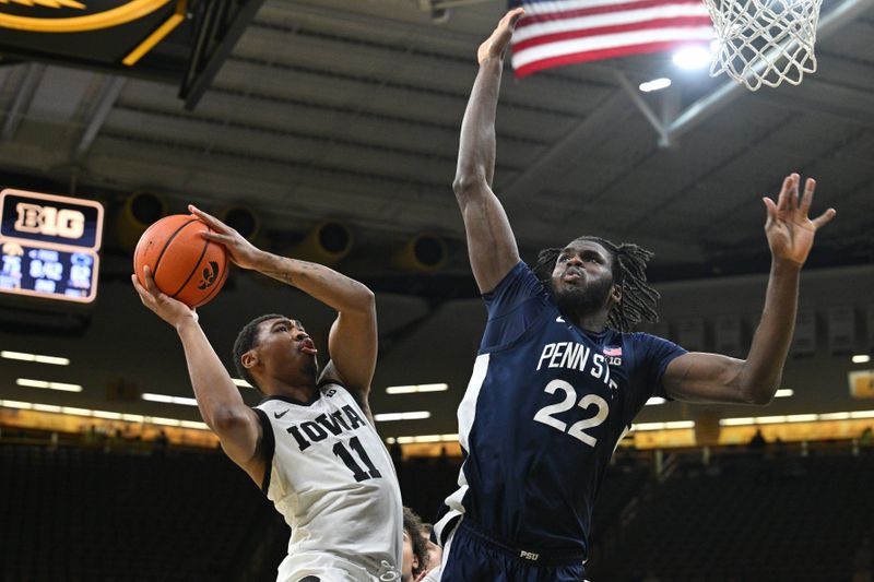 Feb 27, 2024; Iowa City, Iowa, USA; Iowa Hawkeyes guard Tony Perkins (11) shoots the ball as Penn State Nittany Lions forward Qudus Wahab (22) defends during the second half at Carver-Hawkeye Arena. Mandatory Credit: Jeffrey Becker-USA TODAY Sports