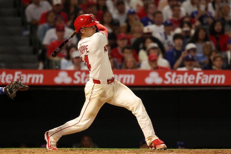 Aug 13, 2025; Anaheim, California, USA;  Los Angeles Angels catcher Logan O'Hoppe (14) hits an RBI single during the eighth inning against the Los Angeles Dodgers at Angel Stadium. Mandatory Credit: Kiyoshi Mio-Imagn Images