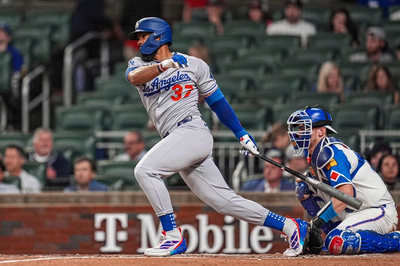 May 3, 2025; Cumberland, Georgia, USA; Los Angeles Dodgers right fielder Teoscar Hernandez (37) singles to drive in a run against the Atlanta Braves during the third inning at Truist Park. Mandatory Credit: Dale Zanine-Imagn Images
