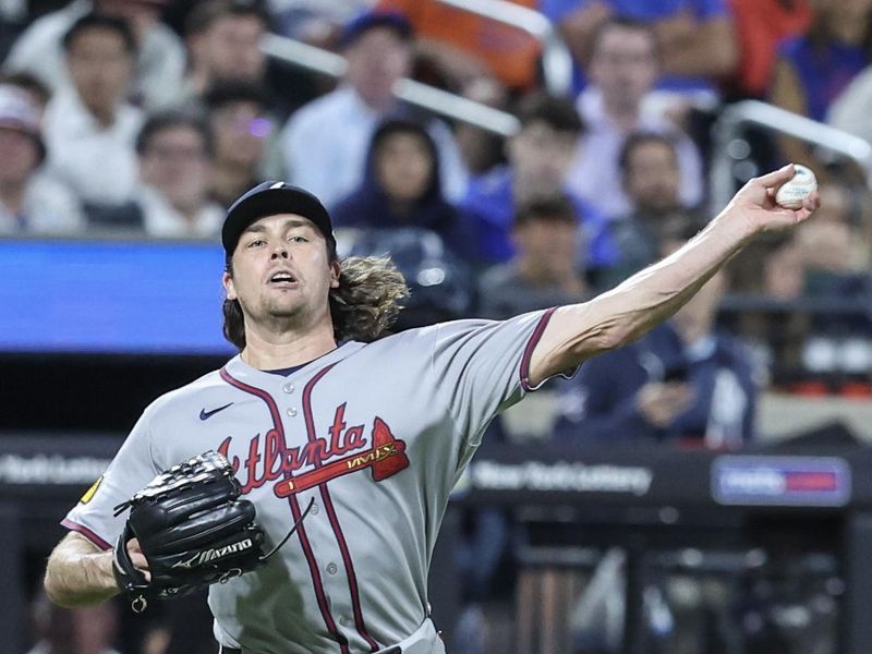 Jun 26, 2025; New York City, New York, USA;  Atlanta Braves relief pitcher Dylan Dodd (46) throws a runner out at first base in the seventh inning against the New York Mets at Citi Field. Mandatory Credit: Wendell Cruz-Imagn Images