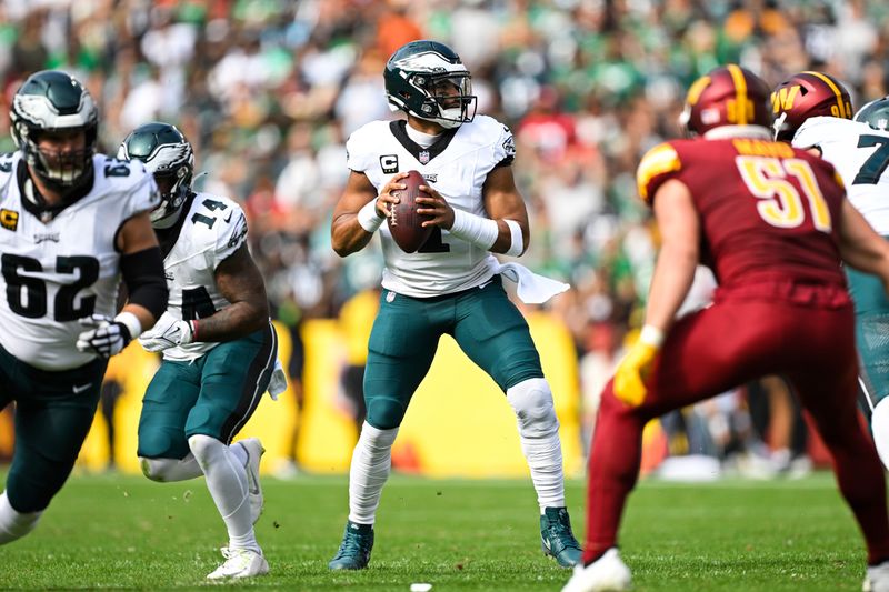 Philadelphia Eagles quarterback Jalen Hurts (1) looks to pass the ball during the first half of an NFL football game against the Washington Commanders, Sunday, Oct. 29, 2023, in Landover, Md. (AP Photo/Terrance Williams)