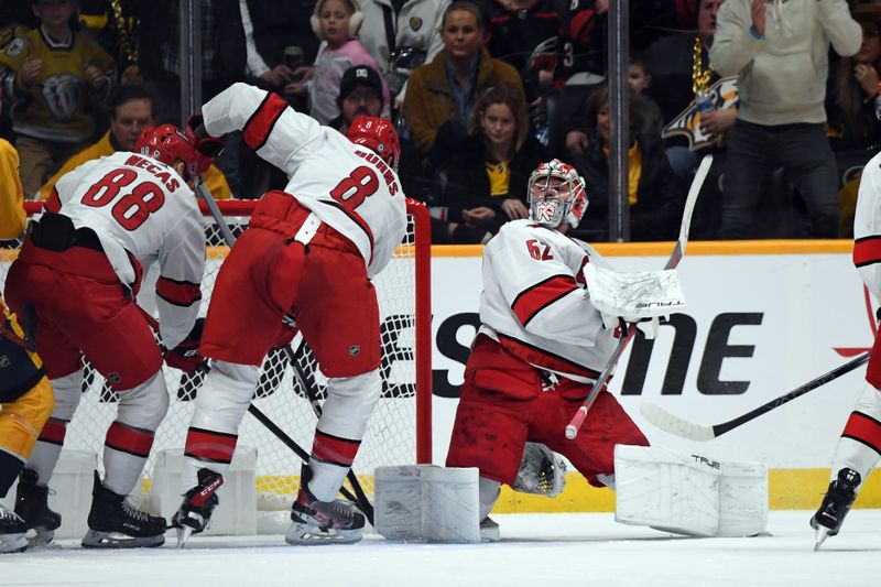 Dec 27, 2023; Nashville, Tennessee, USA; Carolina Hurricanes goaltender Pyotr Kochetkov (52) makes a save during the second period against the Nashville Predators at Bridgestone Arena. Mandatory Credit: Christopher Hanewinckel-USA TODAY Sports