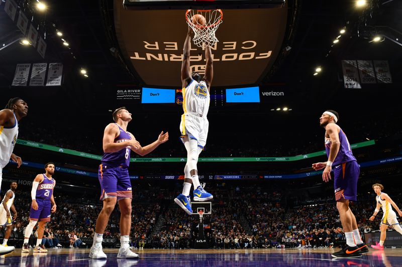 PHOENIX, AZ - NOVEMBER 30: Draymond Green #23 of the Golden State Warriors dunks the ball during the game against the Phoenix Suns on November 30, 2024 at Footprint Center in Phoenix, Arizona. NOTE TO USER: User expressly acknowledges and agrees that, by downloading and or using this photograph, user is consenting to the terms and conditions of the Getty Images License Agreement. Mandatory Copyright Notice: Copyright 2024 NBAE (Photo by Barry Gossage/NBAE via Getty Images)