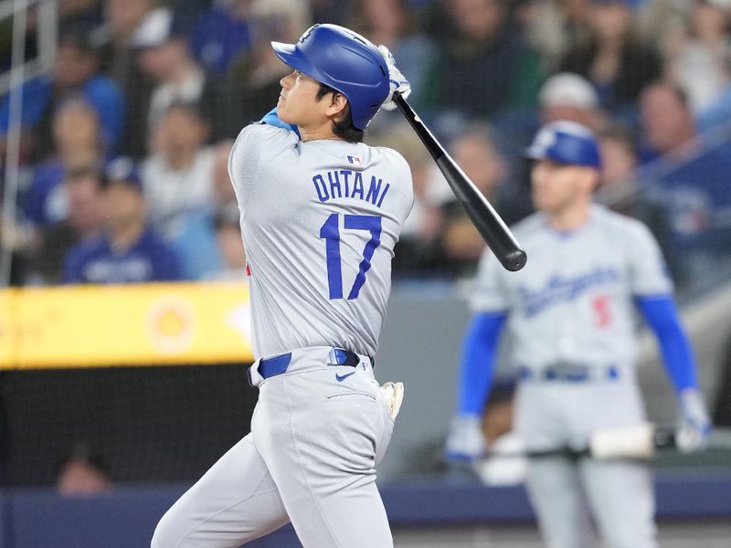 Apr 26, 2024; Toronto, Ontario, CAN; Los Angeles Dodgers designated hitter Shohei Ohtani (17) hits a home run against the Toronto Blue Jays during the first inning at Rogers Centre. Mandatory Credit: Nick Turchiaro-USA TODAY Sports