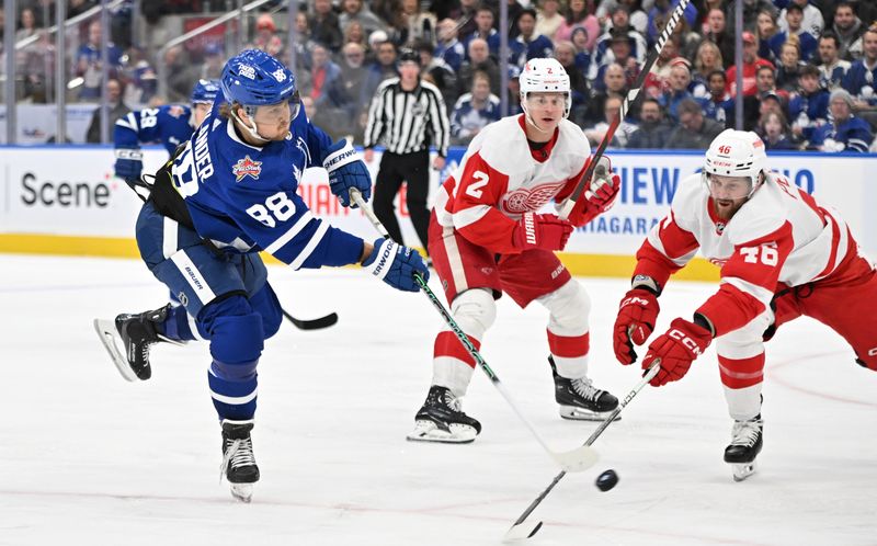 Jan 14, 2024; Toronto, Ontario, CAN;  Toronto Maple Leafs forward William Nylander (88) shoots the puck against Detroit Red Wings defensemen Jeff Petry (46) and Olli Maatta (2) in the third period at Scotiabank Arena. Mandatory Credit: Dan Hamilton-USA TODAY Sports