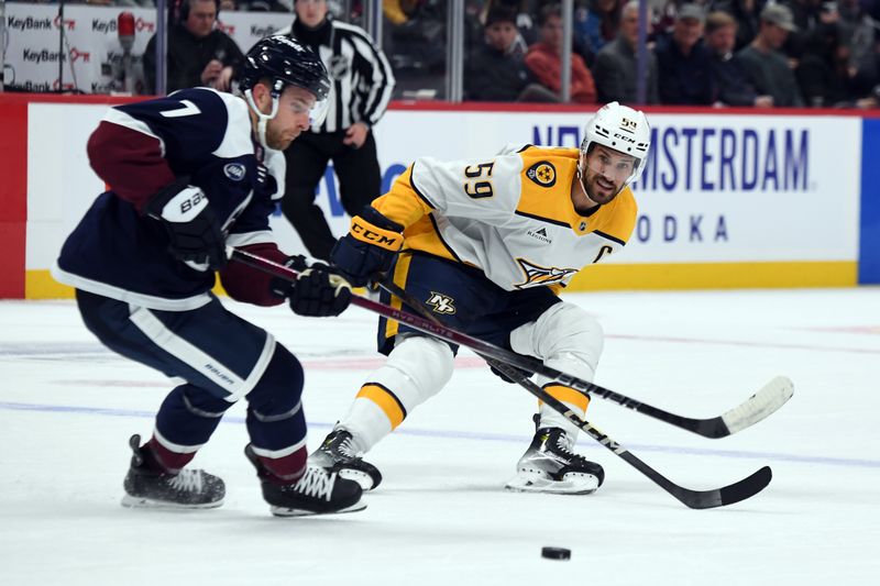 Nov 11, 2024; Denver, Colorado, USA; Nashville Predators defenseman Roman Josi (59) plays the puck against Colorado Avalanche defenseman Devon Toews (7) during the first period at Ball Arena. Mandatory Credit: Christopher Hanewinckel-Imagn Images