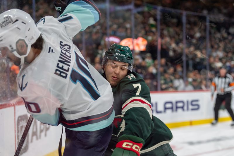 Oct 12, 2024; Saint Paul, Minnesota, USA; Minnesota Wild defenseman Brock Faber (7) checks Seattle Kraken center Matty Beniers (10) in the third period at Xcel Energy Center. Mandatory Credit: Matt Blewett-Imagn Images