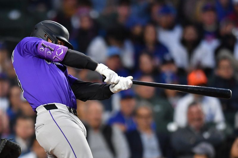 May 27, 2025; Chicago, Illinois, USA; Colorado Rockies third baseman Ryan McMahon (24) hits an RBI single during the fourth inning against the Chicago Cubs at Wrigley Field. Mandatory Credit: Patrick Gorski-Imagn Images
