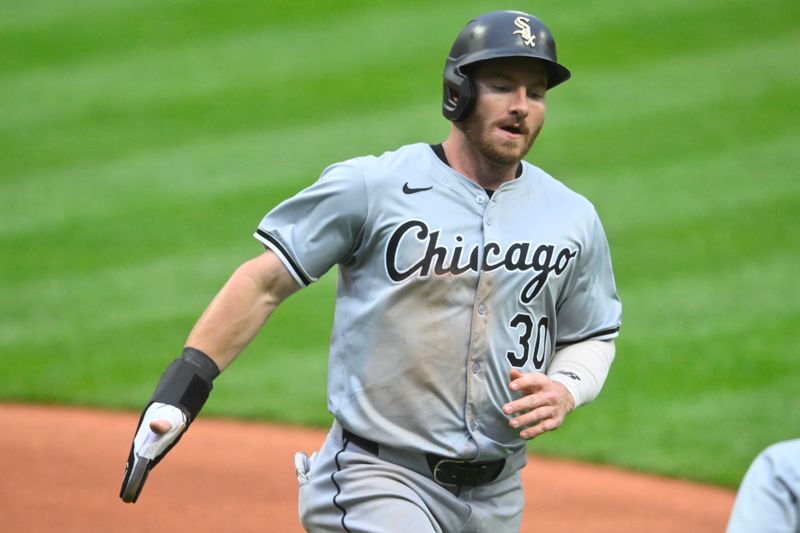 Apr 10, 2024; Cleveland, Ohio, USA; Chicago White Sox outfielder Robbie Grossman (30) scores in the first inning against the Cleveland Guardians at Progressive Field. Mandatory Credit: David Richard-USA TODAY Sports