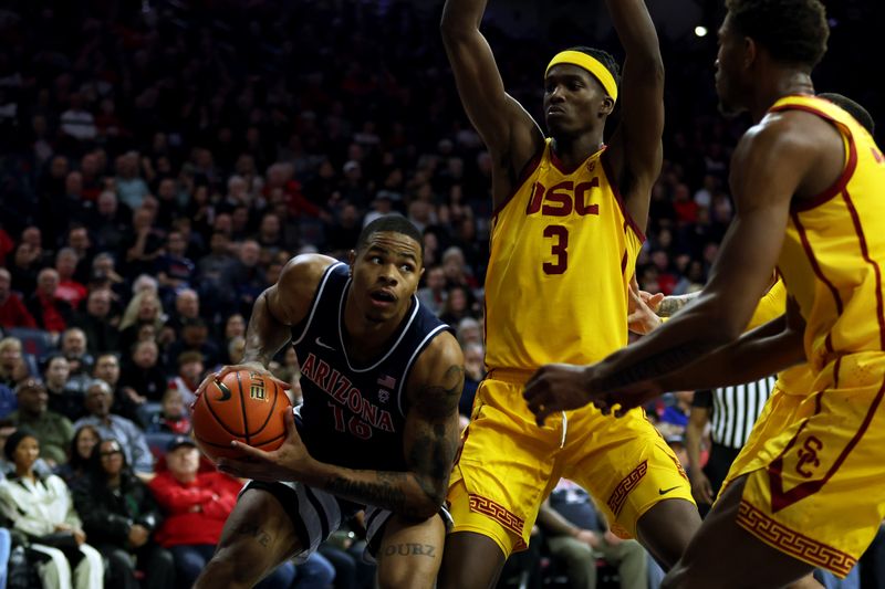 Jan 17, 2024; Tucson, Arizona, USA; Arizona Wildcats forward Keshad Johnson (16) makes a pass against USC Trojans forward Vincent Iwuchukwu (3) during the second half at McKale Center. Mandatory Credit: Zachary BonDurant-USA TODAY Sports