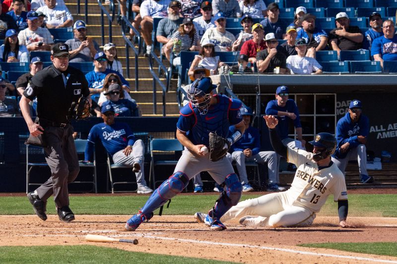 Mar 2, 2024; Phoenix, Arizona, USA; Los Angeles Dodgers catcher Austin Barnes (15) puts his foot on the base ahead of the slide of Milwaukee Brewers catcher Eric Haase (13) to make the out in the third during a spring training game at American Family Fields of Phoenix. Mandatory Credit: Allan Henry-USA TODAY Sports