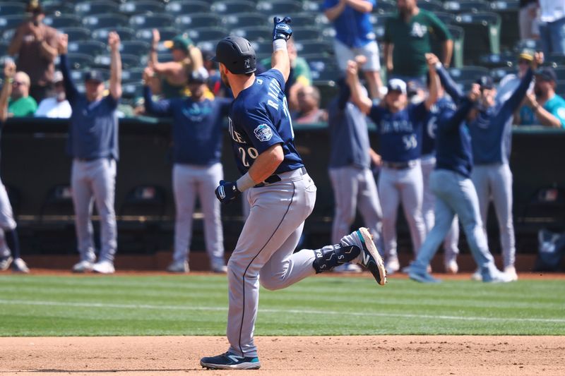 Sep 20, 2023; Oakland, California, USA; Seattle Mariners catcher Cal Raleigh (29) gestures towards teammates as he rounds the bases on a solo home run against the Oakland Athletics during the fifth inning at Oakland-Alameda County Coliseum. Mandatory Credit: Kelley L Cox-USA TODAY Sports