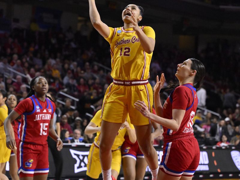 Mar 25, 2024; Los Angeles, CA, USA; USC Trojans guard JuJu Watkins (12) scores past Kansas Jayhawks guard Holly Kersgieter (13) during an NCAA Women’s Tournament 2nd round game at Galen Center. Mandatory Credit: Robert Hanashiro-USA TODAY Sports