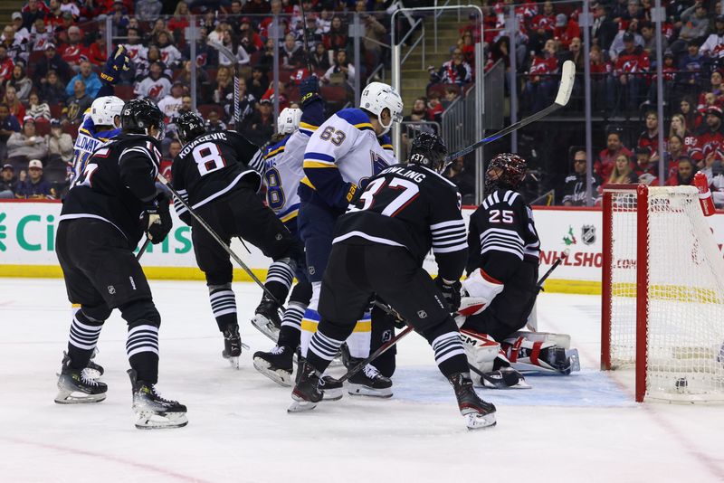 Nov 27, 2024; Newark, New Jersey, USA; St. Louis Blues center Dylan Holloway (81) celebrates his goal against the New Jersey Devils during the first period at Prudential Center. Mandatory Credit: Ed Mulholland-Imagn Images