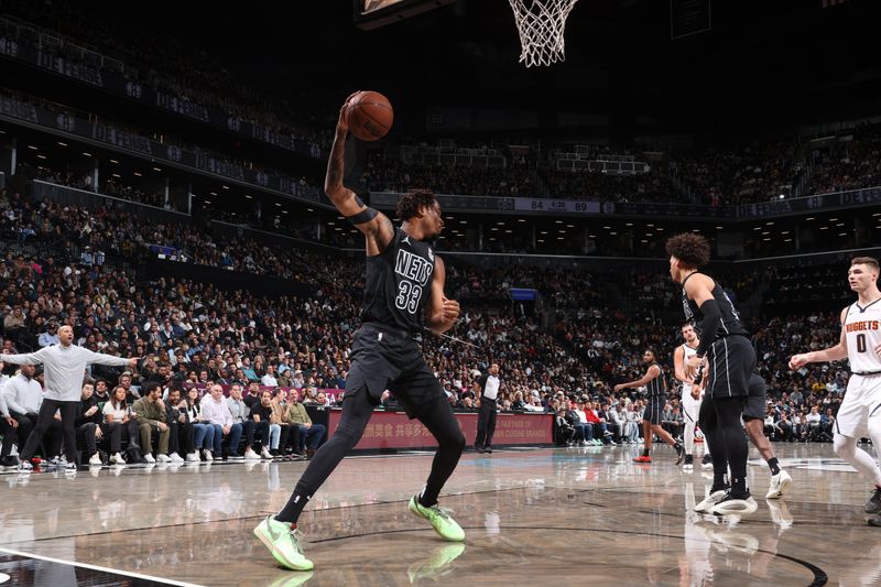 BROOKLYN, NY - OCTOBER 29: Nicolas Claxton #33 of the Brooklyn Nets handles the ball during the game against the Denver Nuggets on October 29, 2024 at Barclays Center in Brooklyn, New York. NOTE TO USER: User expressly acknowledges and agrees that, by downloading and or using this Photograph, user is consenting to the terms and conditions of the Getty Images License Agreement. Mandatory Copyright Notice: Copyright 2024 NBAE (Photo by Nathaniel S. Butler/NBAE via Getty Images)