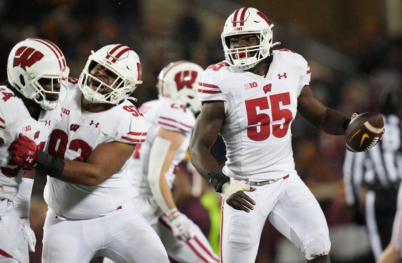 Nov 25, 2023; Minneapolis, Minnesota, USA; Wisconsin Badgers linebacker Maema Njongmeta (55) celebrates after a fumble recovery against the Minnesota Golden Gophers during the fourth quarter at Huntington Bank Stadium. Mandatory Credit: Mark Hoffman/Milwaukee Journal Sentinel via USA TODAY NETWORK