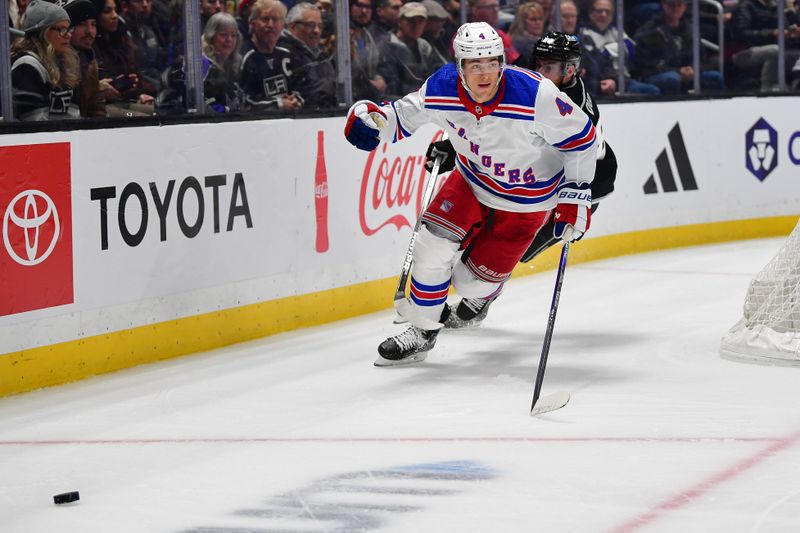 Jan 20, 2024; Los Angeles, California, USA; New York Rangers defenseman Braden Schneider (4) moves in for the puck ahead of Los Angeles Kings center Pierre-Luc Dubois (80) durng the second period at Crypto.com Arena. Mandatory Credit: Gary A. Vasquez-USA TODAY Sports