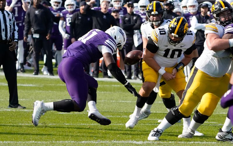 Nov 4, 2023; Chicago, Illinois, USA; Northwestern Wildcats defensive lineman Jaylen Pate (41) strips the ball from Iowa Hawkeyes quarterback Deacon Hill (10) during the first half at Wrigley Field. Mandatory Credit: David Banks-USA TODAY Sports