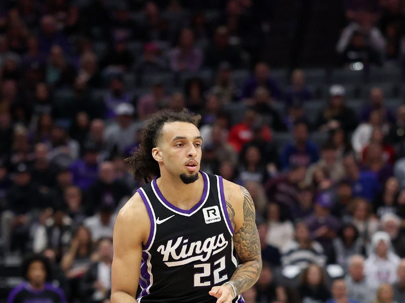 SACRAMENTO, CALIFORNIA - JANUARY 03: Devin Carter #22 of the Sacramento Kings in action against the Memphis Grizzlies in the first half at Golden 1 Center on January 03, 2025 in Sacramento, California. Carter is making his NBA debut in tonight's game. NOTE TO USER: User expressly acknowledges and agrees that, by downloading and/or using this photograph, user is consenting to the terms and conditions of the Getty Images License Agreement.   (Photo by Ezra Shaw/Getty Images)