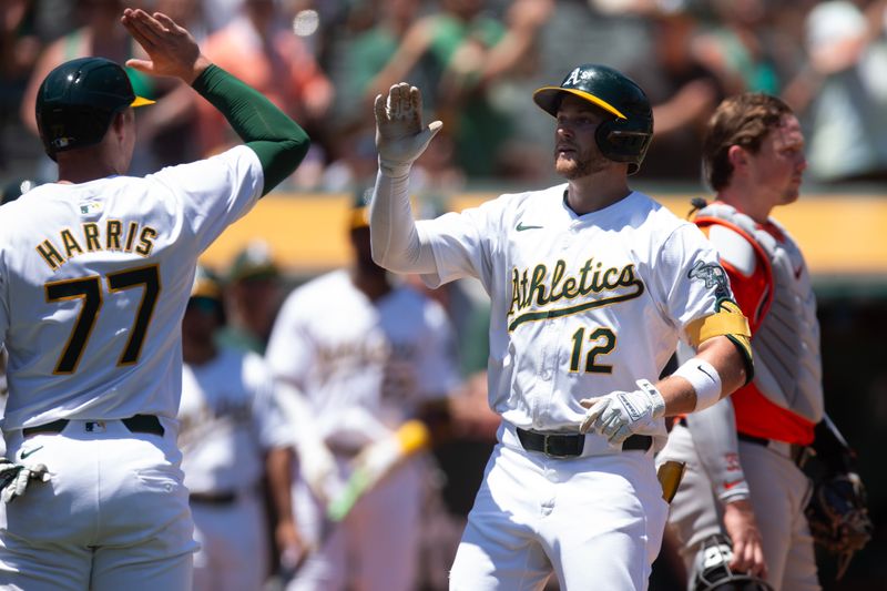 Jul 6, 2024; Oakland, California, USA; Oakland Athletics shortstop Max Schuemann (12) celebrates his three-run home run against the Baltimore Orioles during the second inning at Oakland-Alameda County Coliseum. Mandatory Credit: D. Ross Cameron-USA TODAY Sports