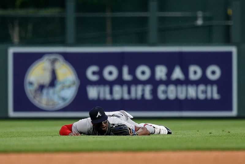 Aug 10, 2024; Denver, Colorado, USA; Atlanta Braves right fielder Jorge Soler (2) lies on the field after a play in the third inning against the Colorado Rockies at Coors Field. Mandatory Credit: Isaiah J. Downing-USA TODAY Sports