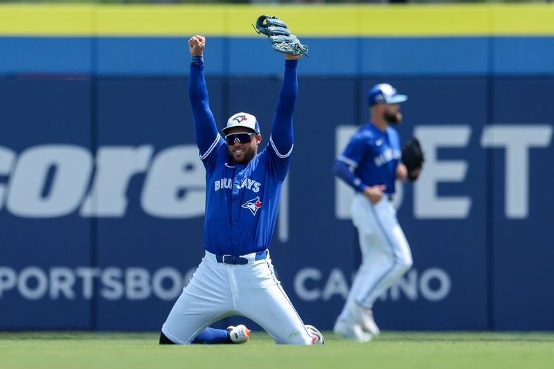 Mar 23, 2025; Dunedin, Florida, USA; Toronto Blue Jays outfielder George Springer (4) celebrates after making a play against the Pittsburgh Pirates in the third inning during spring training at TD Ballpark. Mandatory Credit: Nathan Ray Seebeck-Imagn Images