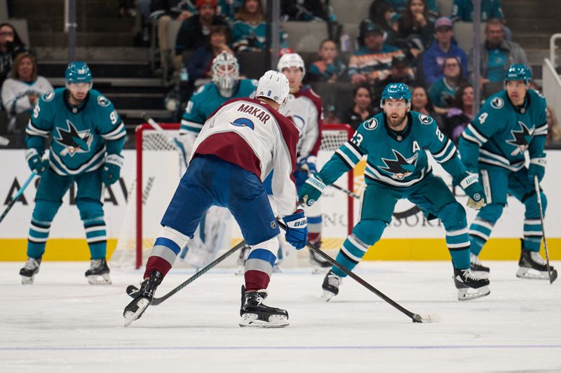 Oct 20, 2024; San Jose, California, USA; Colorado Avalanche defenseman Cale Makar (8) controls the puck against San Jose Sharks right wing Barclay Goodrow (23), defenseman Jake Walman (96) and defenseman Cody Ceci (4) during the second period at SAP Center at San Jose. Mandatory Credit: Robert Edwards-Imagn Images