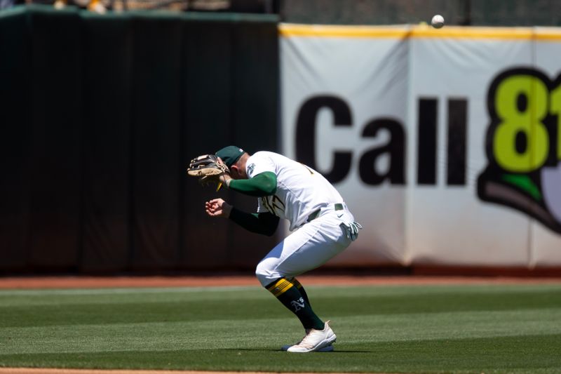 Jul 7, 2024; Oakland, California, USA; Oakland Athletics third baseman Brett Harris (77) loses a popup by Baltimore Orioles right fielder Anthony Santander (25) in the sun during the third inning at Oakland-Alameda County Coliseum. Mandatory Credit: D. Ross Cameron-USA TODAY Sports