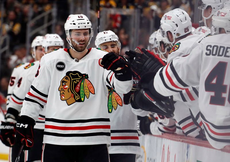 Oct 10, 2023; Pittsburgh, Pennsylvania, USA; Chicago Blackhawks center Jason Dickinson (16) celebrates with the Chicago bench after scoring the game winning goal against the Pittsburgh Penguins during the third period at the PPG Paints Arena. Chicago won 4-2. Mandatory Credit: Charles LeClaire-USA TODAY Sports