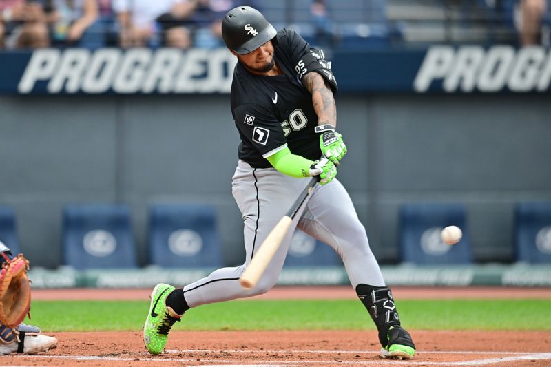 Sep 13, 2025; Cleveland, Ohio, USA; Chicago White Sox second baseman Lenyn Sosa (50) hits an RBI single against the Cleveland Guardians during the first inning at Progressive Field. Mandatory Credit: Ken Blaze-Imagn Images