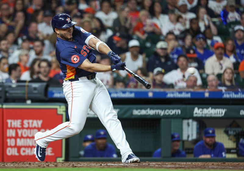 Apr 2, 2024; Houston, Texas, USA; Houston Astros designated hitter Yainer Diaz (21) hits a double during the fifth inning against the Toronto Blue Jays at Minute Maid Park. Mandatory Credit: Troy Taormina-USA TODAY Sports