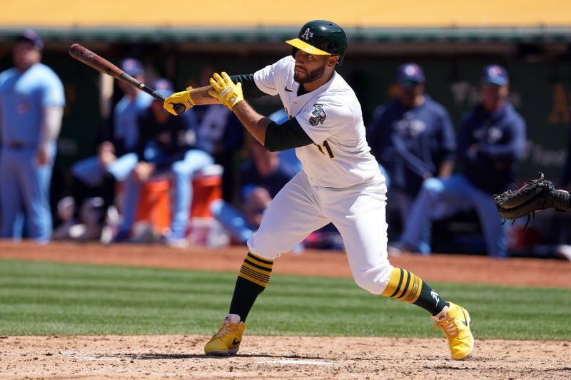 Jun 9, 2024; Oakland, California, USA; Oakland Athletics third baseman Abraham Toro (31) hits an RBI single against the Toronto Blue Jays during the seventh inning at Oakland-Alameda County Coliseum. Mandatory Credit: Darren Yamashita-USA TODAY Sports