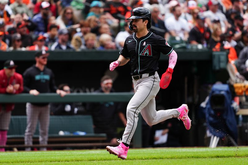 May 12, 2024; Baltimore, Maryland, USA; Arizona Diamondbacks center fielder Corbin Carroll (7) scores a run on first baseman Christian Walker (not pictured) sacrifice fly ball against the Baltimore Orioles during the fourth inning at Oriole Park at Camden Yards. Mandatory Credit: Gregory Fisher-USA TODAY Sports