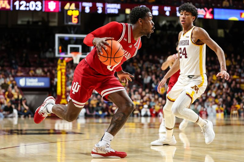Mar 6, 2024; Minneapolis, Minnesota, USA; Indiana Hoosiers guard Xavier Johnson (0) works around Minnesota Golden Gophers guard Cam Christie (24) during the second half at Williams Arena. Mandatory Credit: Matt Krohn-USA TODAY Sports