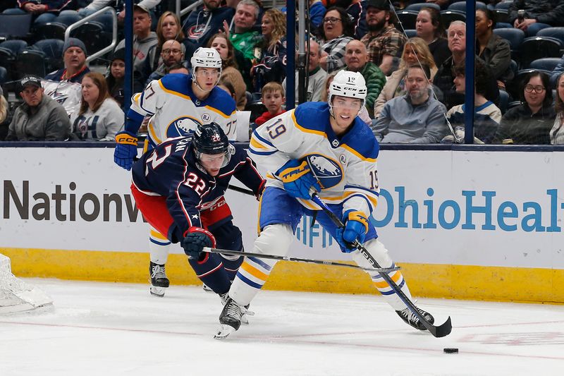 Feb 23, 2024; Columbus, Ohio, USA; Buffalo Sabres center Peyton Krebs (19) looks to pass as Columbus Blue Jackets defenseman Jake Bean (22) trails the play during the second period at Nationwide Arena. Mandatory Credit: Russell LaBounty-USA TODAY Sports