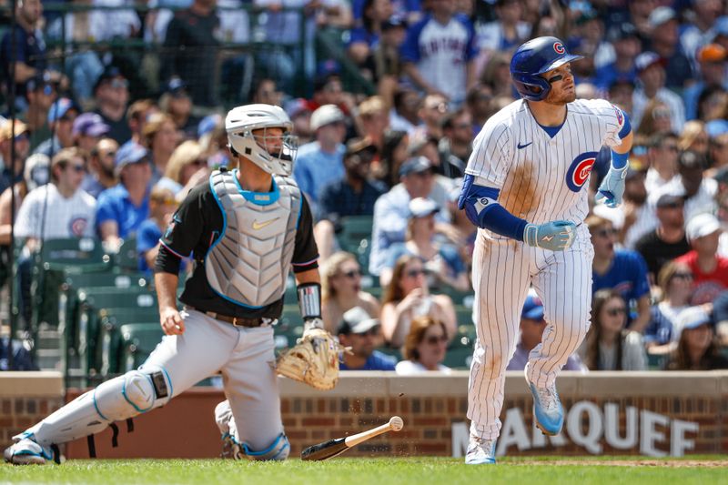 May 5, 2023; Chicago, Illinois, USA; Chicago Cubs left fielder Ian Happ (8) watches his two-run home run against the Miami Marlins during the fifth inning at Wrigley Field. Mandatory Credit: Kamil Krzaczynski-USA TODAY Sports