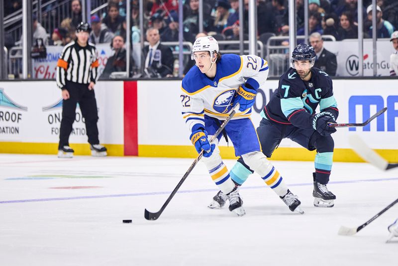 Dec 14, 2025; Seattle, Washington, USA; Buffalo Sabres right wing Jack Quinn (22) looks to pass as Seattle Kraken right wing Jordan Eberle (7) defends during the first period at Climate Pledge Arena. Mandatory Credit: Blake Dahlin-Imagn Images