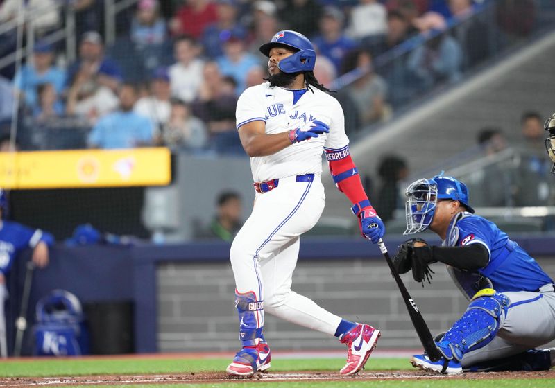 May 1, 2024; Toronto, Ontario, CAN; Toronto Blue Jays first base Vladimir Guerrero Jr. (27) hits a single against the Kansas City Royals during the first inning at Rogers Centre. Mandatory Credit: Nick Turchiaro-USA TODAY Sports