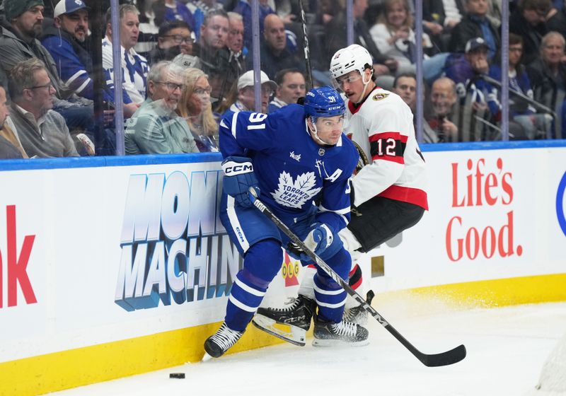 Nov 12, 2024; Toronto, Ontario, CAN; Toronto Maple Leafs center John Tavares (91) battles for the puck with Ottawa Senators center Shane Pinto (12) during the third period at Scotiabank Arena. Mandatory Credit: Nick Turchiaro-Imagn Images